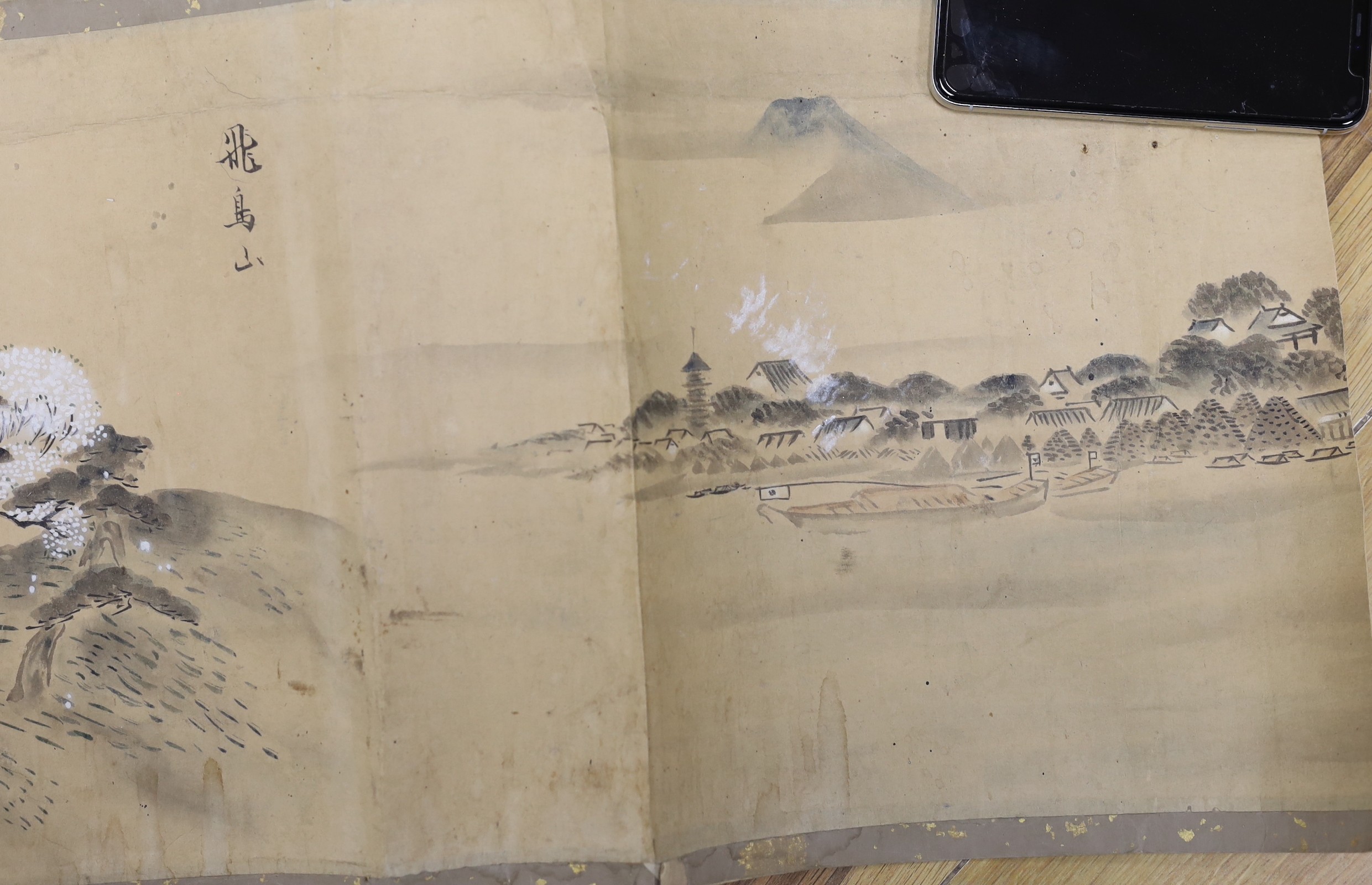 A Japanese landscape painting on paper hand scroll, Edo period, titled views, now in two parts, incomplete, image 27cm high x approximately 470cm wide